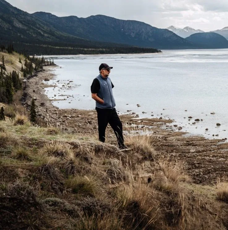Azhar Hameed walking along a lakeshore